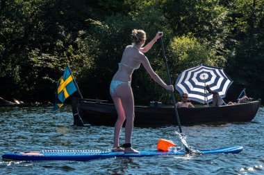 Stockholm, Sweden People riding stand up paddle boards in the summer