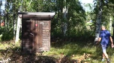 Skellefte, Sweden A man uses an outhouse to go to the toilet.