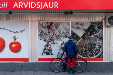 Arvidsjaur, Sweden Men  chatting in front of the local ICA supermarket.