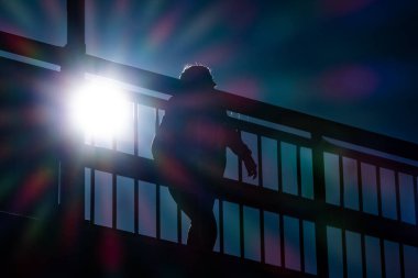 Skelleftea, Sweden A man walks over a bridge in the strong sunlight