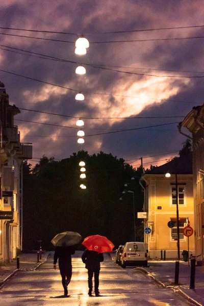 Skelleftea Sweden Two Men Umbrellas Walking Rainy Street Night — Stock Photo, Image