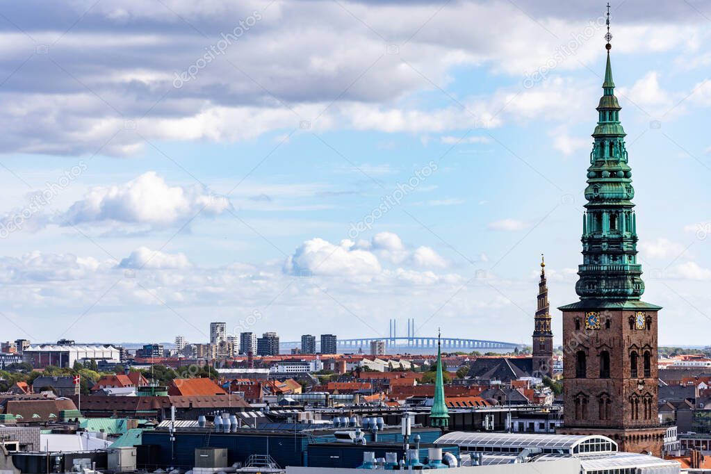 Copenhagen, Denmark Rooftops of the city.and the St Nikolaj Church, now a contemporary art center, and the Oresudn bridge to Sweden in the distance.