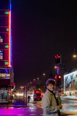 Kopenhag, Danimarka. Burgerli genç bir adam H.C. Andersen Bulvarı 'ndaki ünlü termometrenin önünde poz veriyor..
