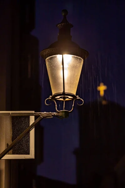 Copenhagen, Denmark A street lamp at night in the old town.