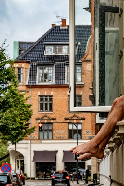 Copenhagen Denmark Man Hangs Out His Feet Window Street Fredriksberg — Stock Fotó