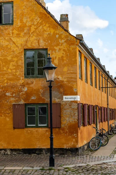 丹麦哥本哈根 历史上著名的尼伯德地区 骑自行车的人经过一排房子 — 图库照片