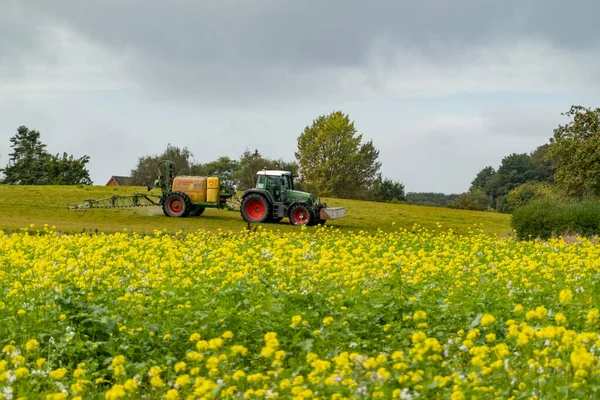 Lolland, Denmark A tractor fertilizing a field.