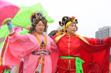 İnsanlar renkli kıyafetler giyer, Yanko dans gösterileri yapar.