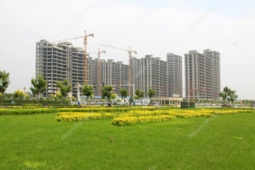 green lawns and high rise building construction site