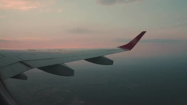 Passenger window view of commercial aircraft at sunset — Stock Video