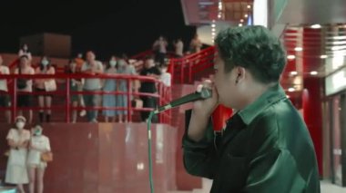 XIAN, Çin - 12. Sezon 2021: Geceleri sokakta şarkı söyleyen şarkıcı. Çin, Xian.