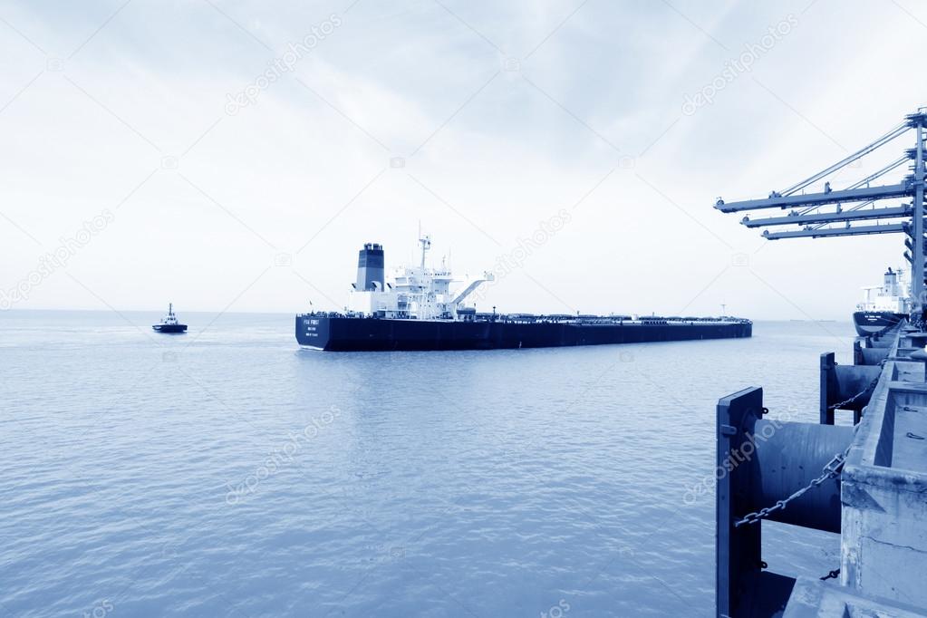 Cargo ships in the  vicinity of a wharf