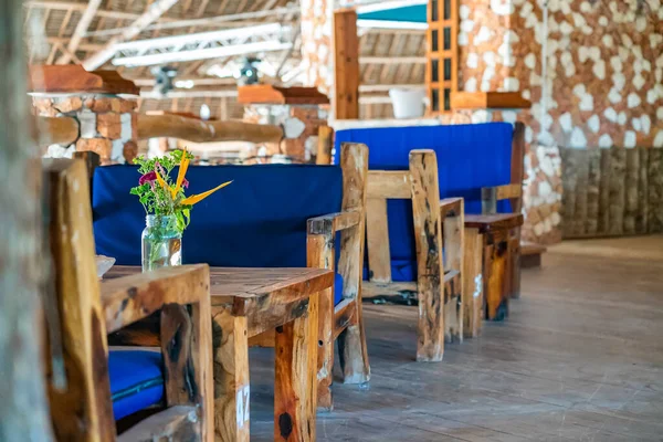 Wooden tables in cafe. Authentic interior of restaurant in Kendwa, Zanzibar, Tanzania. — Stock Photo, Image