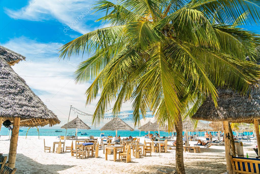 Restaurant on the sand with palms. Zanzibar, Tanzania