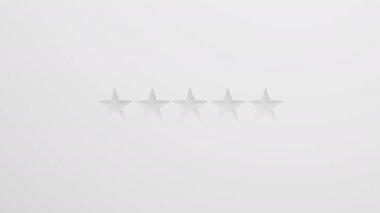 Beyaz arka planda beş altın yıldız. Yıldızlar canlanıyor