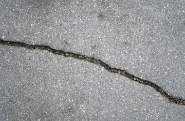 Doku. Çatlak asfalt dokusu. Yukarıdan bak. Yakın plan.