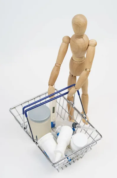 Business Concept Wooden Man Holds Shopping Basket Medicines Isolated White — Stock Photo, Image