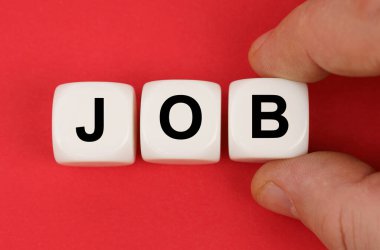 İş ve finans. Kırmızı yüzeyde, üzerinde yazı olan beyaz küpler- JoB