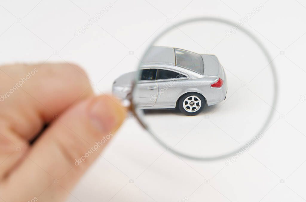 The car is being examined by a mechanic. Car service and purchase concept. Isolated on white background.