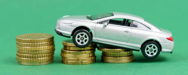The toy car moves up the coins. Isolated on green background. — Foto Stock