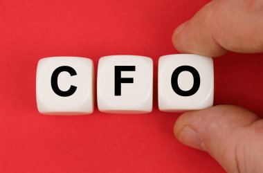 On the red surface, white cubes with the inscription - CFO