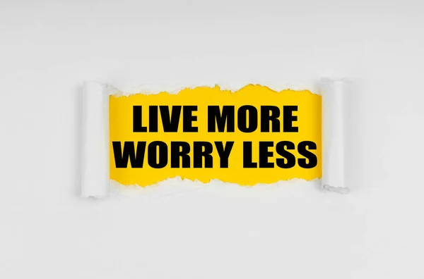 A window is made in the paper, where on a yellow background the inscription - Live More Worry Less — Stock fotografie