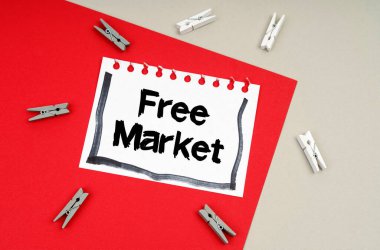 Clothespins and a sheet of notebook with the inscription - Free Market