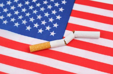 No smoking concept. A broken cigarette is on the US flag as a symbol of the harm of smoking.