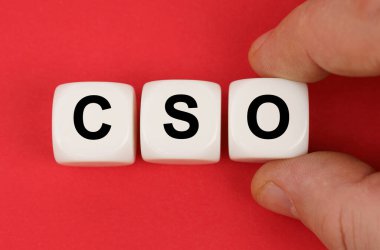 Business and finance. On the red surface, white cubes with the inscription - CSO
