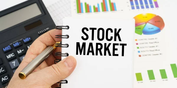 Finance Economics Concept Man Holding Pen Notebook Inscription Stock Market — Stok fotoğraf