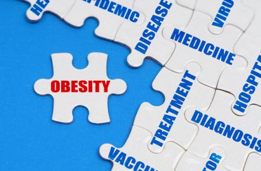 On the blue surface, puzzles with medical inscriptions, on a separate puzzle it is written - OBESITY