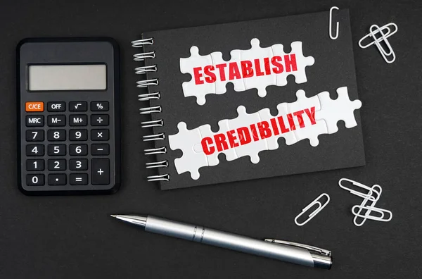 Business Economics Table Calculator Pen Notebook Inscription Establish Credibility —  Fotos de Stock