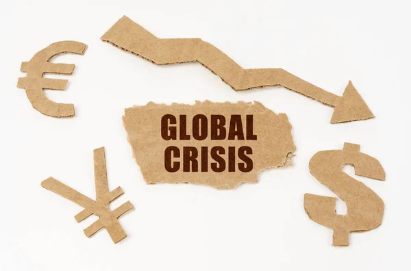 Op een witte achtergrond, valuta symbolen, een pijl en een kartonnen doos met de inscriptie - wereldwijde crisis — Stockfoto