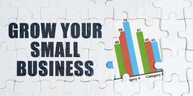 Ekonomi ve iş kavramı. Beyaz bulmacalarda bir yazı var: 