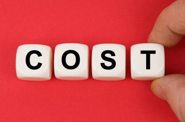 İş ve finans. Kırmızı yüzeyde, üzerinde yazı olan beyaz küplerin fiyatı