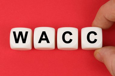 İş ve finans. Kırmızı yüzeyde, üzerinde WACC yazan beyaz küpler.