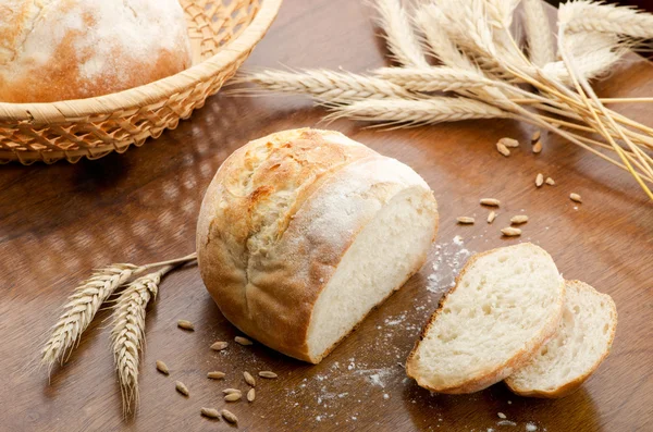 Rustic table with fresh bread — Stock Photo, Image