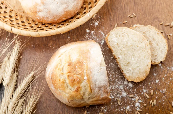 Rustic table with fresh bread — Stock Photo, Image