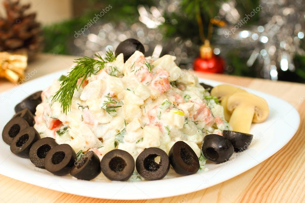 Russian vegetable salad with mushrooms on New Year Eve