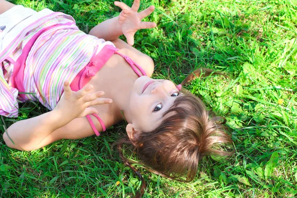 Little girl on green grass — Stock Photo, Image