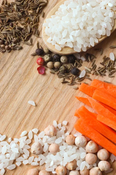 Ingredients for Uzbek pilaf on wooden background — Stock Photo, Image