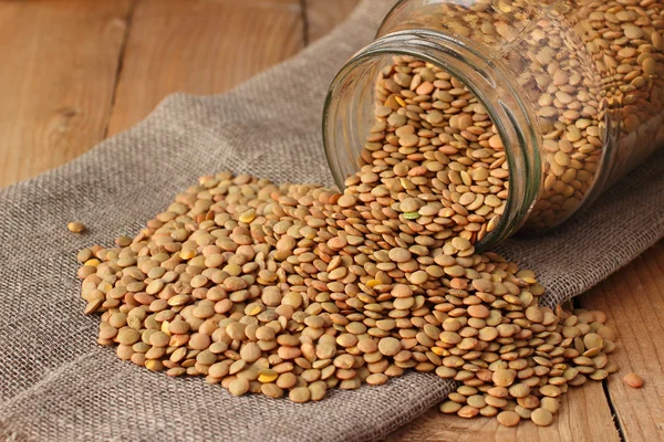 Green lentils with glass jar on wooden table — Stock Photo, Image