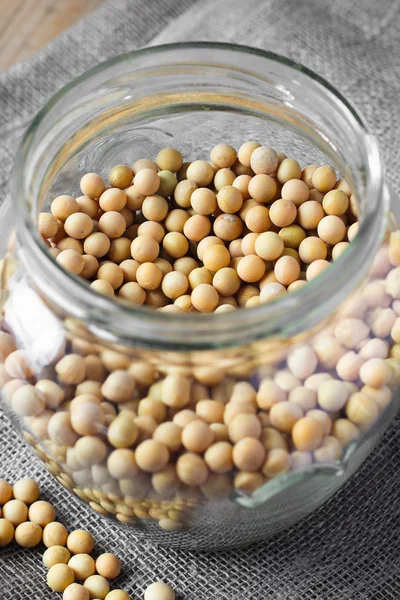 Beans of soya in glass jar — Stock Photo, Image