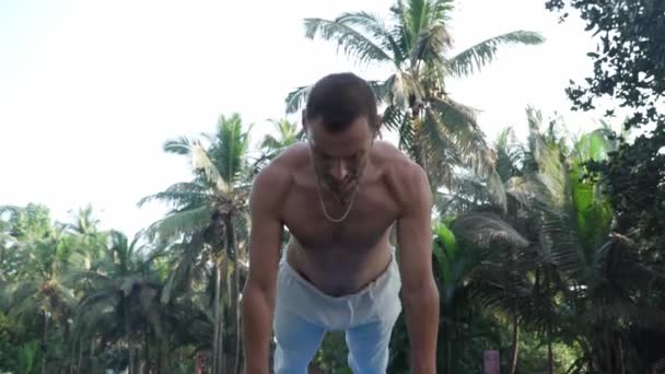 Man is engaged in yoga performing asanas — ストック動画