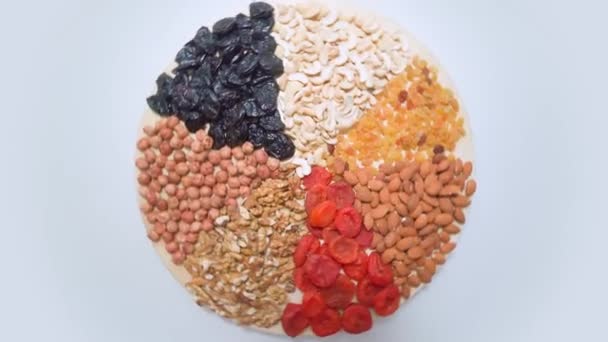 Healthy vegetarian food. Collection of healthy nuts and dried fruits — Stock Video