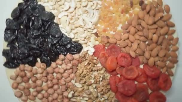 Healthy vegetarian food. Collection of healthy nuts and dried fruits. Close Up — Vídeo de Stock