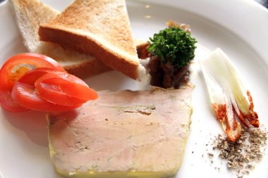 Foie micuit on plate with toasted bread slices