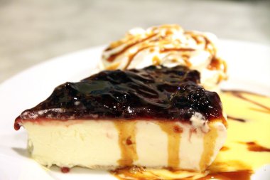 Cheese tart on plate with blackberries jam