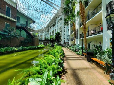 Nashville, Tennessee, U.S.A - June 26, 2022 - The walking path by tropical plants inside of Gaylord Opryland Resort and Convention Center