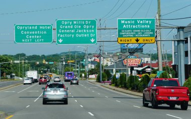 Nashville, Tennessee, U.S.A - June 23, 2022 - The road signs into Opryland Hotel Convention Center, Opry Mills Drive and Grand Ole Opry